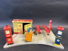 A Marx Toys tinplate filling station 'Sunny Side Service Station' complete with petrol pumps, car