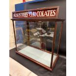 A Victorian/Edwardian mahogany counter top display cabinet with sliding doors to the rear and two