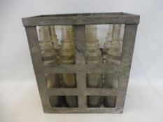 An Essolube eight division crate containing a full set of glass oil bottles.