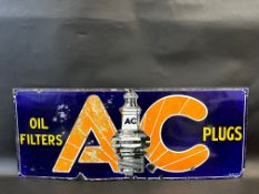 An AC Oil Filters and Plugs rectangular enamel sign with central spark plug image, 30 x 12".