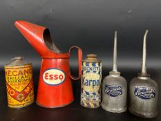 An Esso quart oil measure in good condition, a Carborundum pictorial showcard and various oil cans