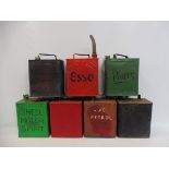 Seven two gallon petrol cans including Esso in circle.