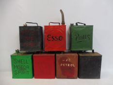 Seven two gallon petrol cans including Esso in circle.