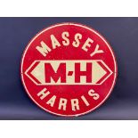 An aluminium circular sign advertising Massey Harris, 21" diameter.