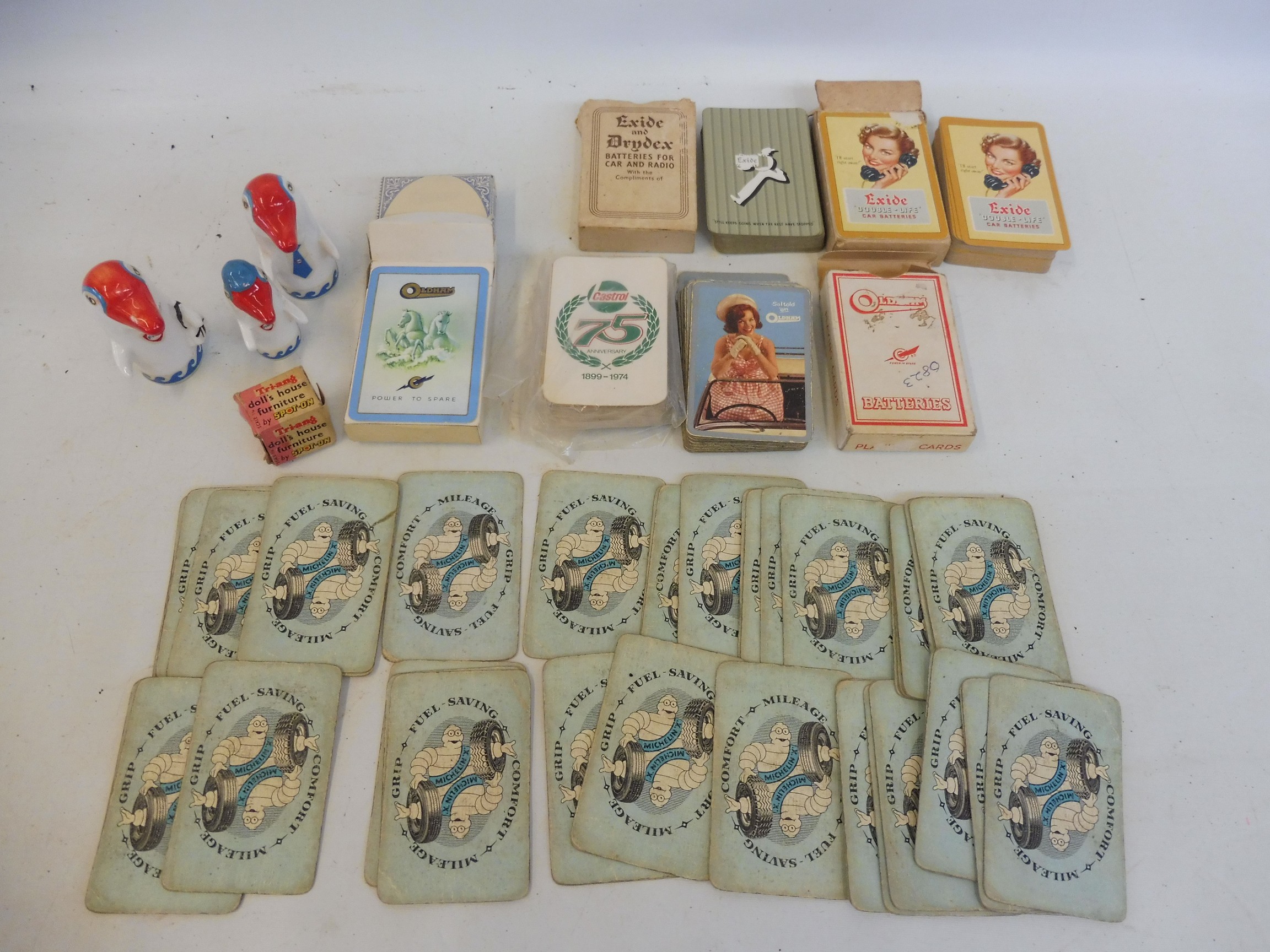 A quantity of playing cards all with motoring advertising including Michelin and Exide, plus two