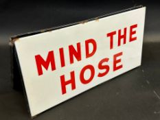 A 'Mind The Hose' folding two piece delivery tanker driver's enamel sign, 18 x 9".