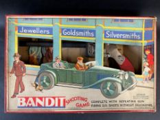 A boxed Chad Valley Bandit Shooting Game, depicting a pre-war open top motor car to the front of the