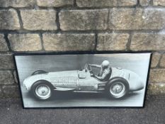 A framed and glazed photographic print of believed Nuvolari driving at speed, 40 x 19 1/2".