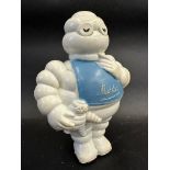 A Michelin squeeze toy in the shape of Mr Bibendum holding a baby Bibendum, still retaining original