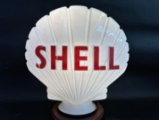 A Shell glass petrol pump globe by Hailware, dated July 1977.