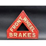 A 1920s triangular sign warning of 'Front Wheel Brakes', made by J.W.& T. Connolly Ltd, Tyre & Motor