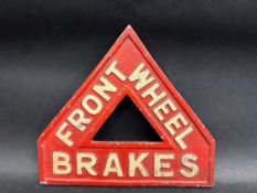 A 1920s triangular sign warning of 'Front Wheel Brakes', made by J.W.& T. Connolly Ltd, Tyre & Motor