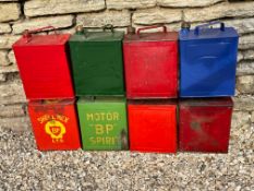 Eight two gallon petrol cans including BP Motor Spirit etc.