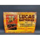 An early Lucas Batteries tin advertising sign with image of a figure on a horse standing on a