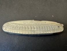 A Dunlop penknife in the shape of a tyre.