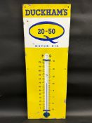 A Duckham's 20-50 Motor Oil enamel thermometer, 13 x 36".