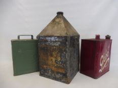 A five gallon pyramid can with remains of NBC paper label, plus two petrol cans.