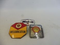 A Shellubrication octagonal enamel lapel badge, a Shell Authorised Dealer badge and a third for