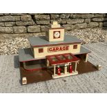 A well made model garage of Art Deco design, featuring two rows of die-cast petrol pumps.