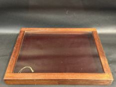 A mahogany counter top display cabinet with rising lid and key, 21" w x 16 1/2" d x 2" h.