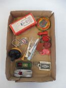 A small tray of petrol conmpany related promotional items including Redex keyrings.