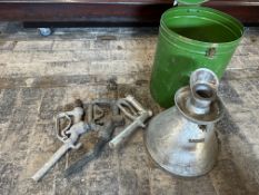 Three petrol pump nozzles and a weights and measures canister.