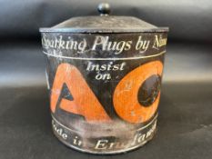 An AC Sparking Plugs circular point of sale tin dispenser with revolving barrel inside.