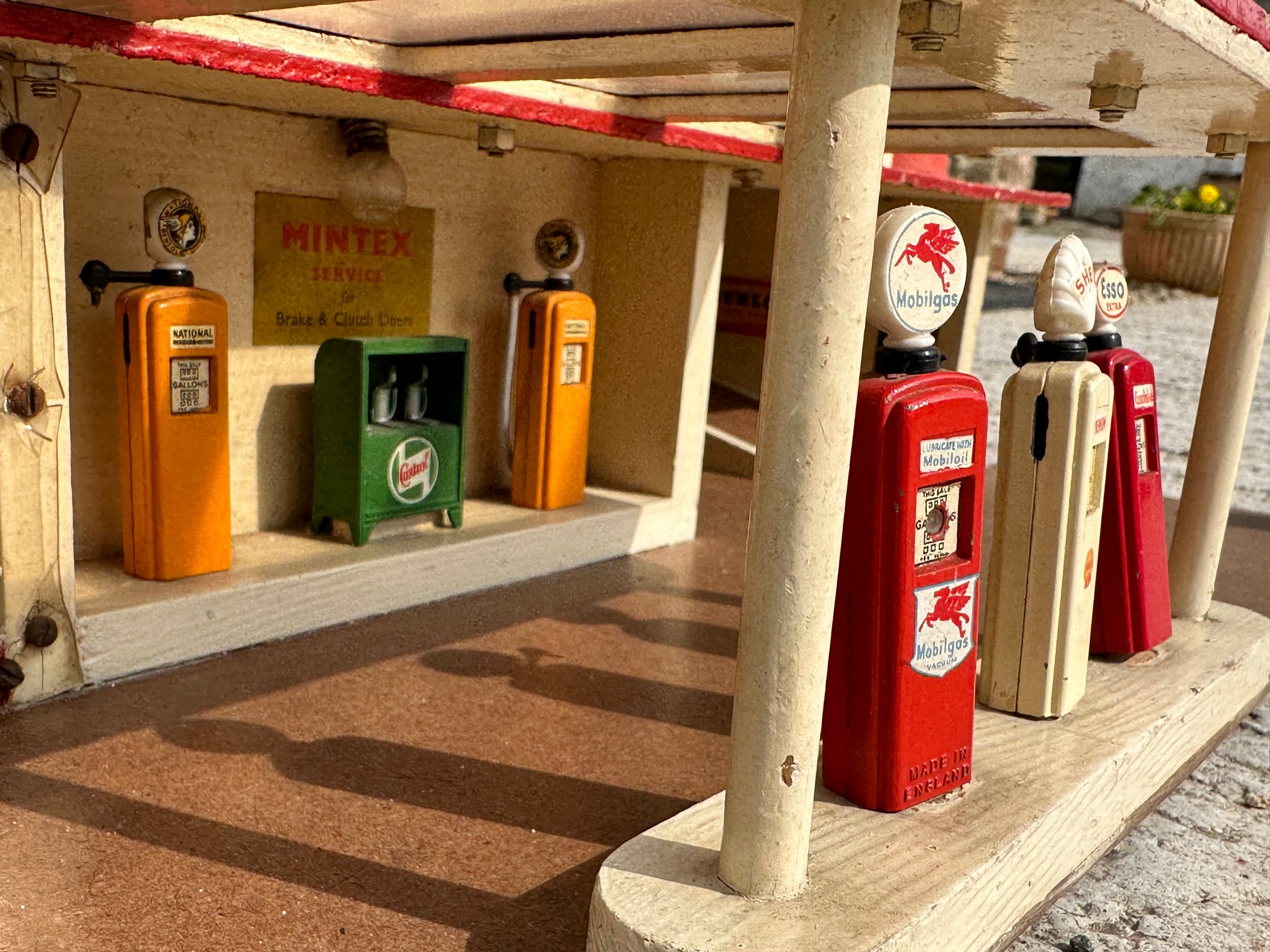 A well made model garage of Art Deco design, featuring two rows of die-cast petrol pumps. - Image 2 of 3