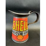 An early Shell Motor Oil quart measure with wide neck, dated 1928.