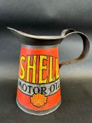 An early Shell Motor Oil quart measure with wide neck, dated 1928.
