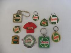 A tray of Castrol branded promotional items including keyrings.