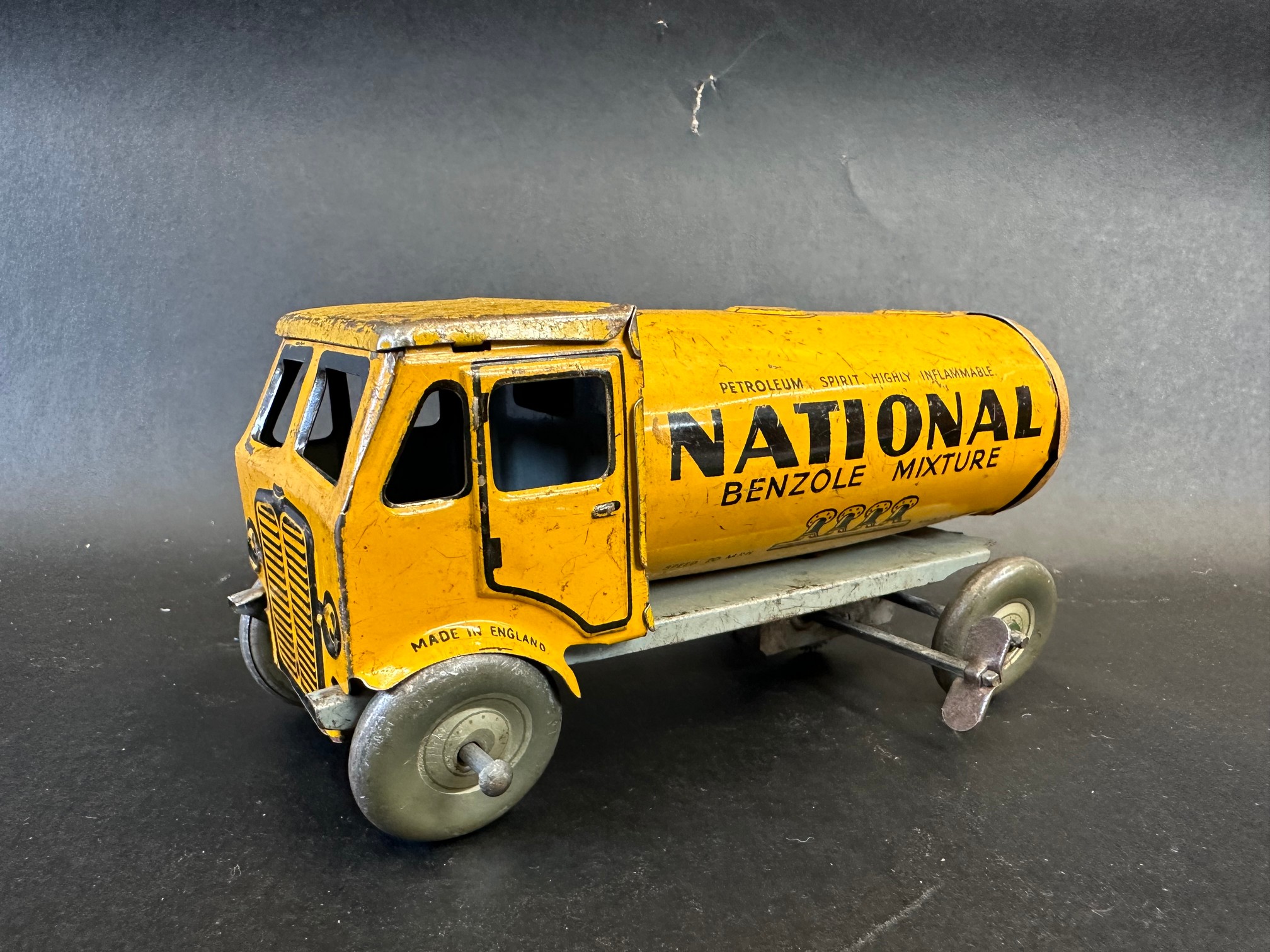 A Mettoy clockwork tinplate model of an National Benzole Mixture tanker.