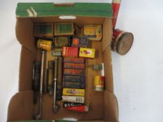 A box of garage packaging including spark plugs and bulbs plus various tyre pressure gauges etc.