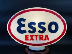 An Esso Extra glass petrol pump globe, fully stamped underneath.