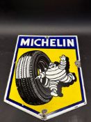 A small Michelin enamel sign depicting Mr. Bibendum rolling a tyre, 12 1/2 x 16 1/2".