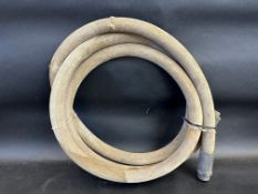 An early canvas petrol pump hose with brass ends.