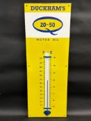 A Duckham's 20-50 Motor Oil enamel thermometer in excellent condition, 13 x 36".