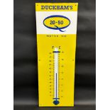 A Duckham's 20-50 Motor Oil enamel thermometer in excellent condition, 13 x 36".