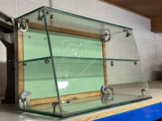 A counter top glass display cabinet with rear opening door, 22" w x 13 1/2" h x 11" d.