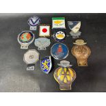 A quantity of assorted car badges.