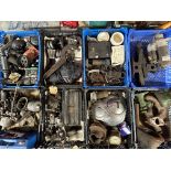 An autojumbler's lot in eight crates of assorted spares including carburettors, manifold etc.