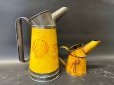 A Shell half gallon measure, dated 1951 and a pint Shell measure with robotman motifs, dated 1938.