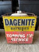 A garage forecourt rack with tin sign to the front advertising Dagenite Batteries 'Topping Up