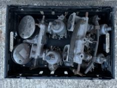 A box of carburettors on manifolds.