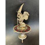 An unusual car accessory mascot in the form of a witch, mounted on a roulette wheel.
