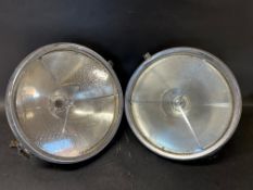 A pair of Lucas P100 headlamps.