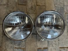 A pair of chrome plated headlamps.