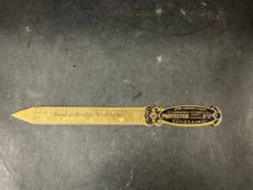 A brass letter opener advertising Protector Lamps.