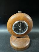 A Smiths eight day car clock in wooden desk mount, with hand carved MG related inscription to the