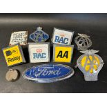 A small enamel vending machine sign and a selection of car badges etc.